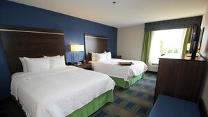 A hotel room with two beds, a desk, a lamp, and a window with curtains. - Hampton Inn Sandusky-Central (Sandusky)