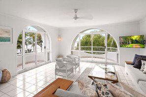3 Bedroom Beach Front Apartment - Complimentary Parking, WiFi and Daily Beach Yoga | Living room | 50-inch Smart TV with digital channels, TV, Netflix