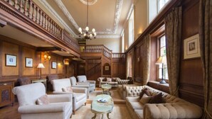 A spacious, elegantly furnished lounge with multiple seating areas, a staircase, and framed artwork on the walls. - Bartley Lodge Hotel (Southampton)