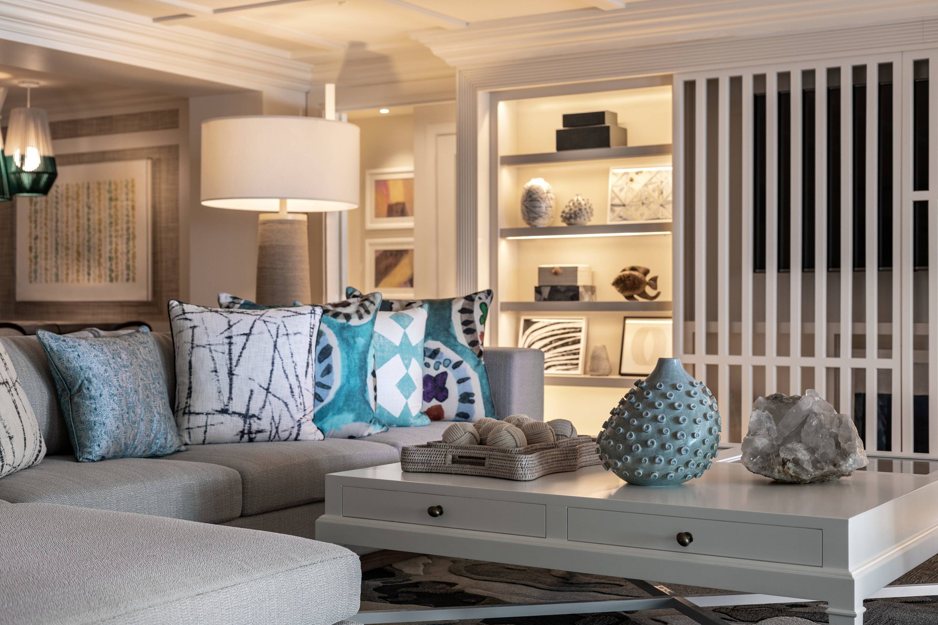A modern living room with a sofa, a coffee table, and decorative items.