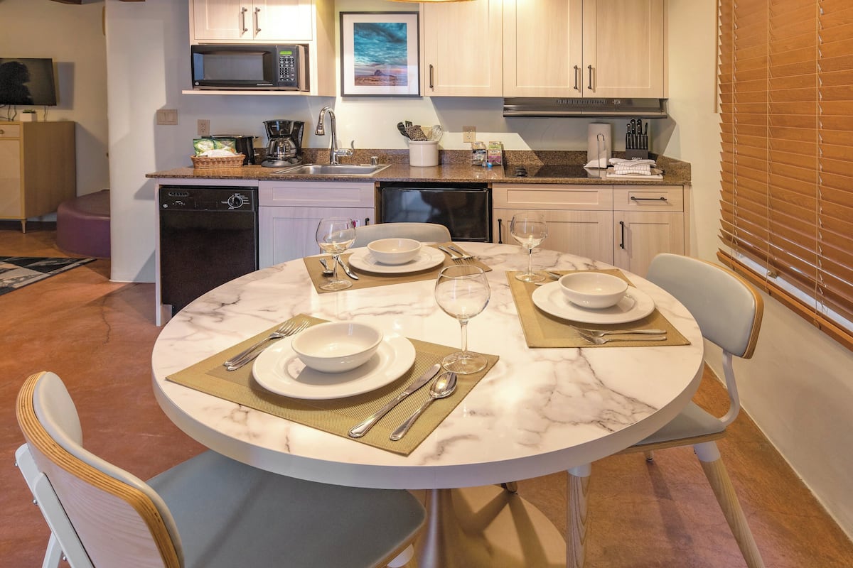 A modern kitchen with a dining area set for a meal.