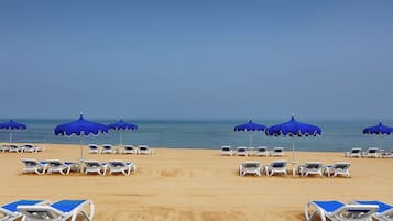 Playa privada, camastros y sombrillas