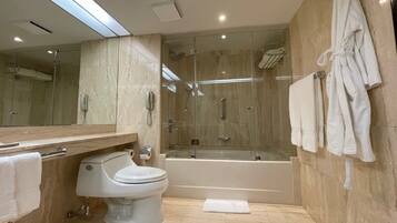 A modern bathroom with a toilet, sink, and bathtub.