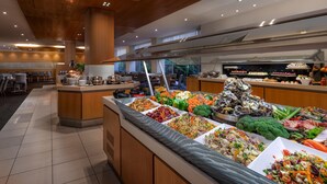 A buffet area with various food options, including salads, fruits, and seafood. - Rydges Rotorua (Rotorua)
