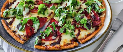 A pizza with various toppings on a plate.