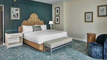 A neatly arranged bedroom with a bed, bedside tables, a bench, and a chair.