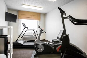 A gym with a treadmill, stationary bike, and a TV mounted on the wall. - Sleep Inn Rockford I-90 (Rockford)