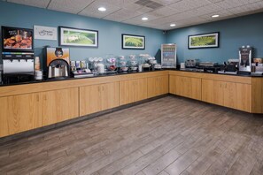 A coffee shop with a counter, coffee machines, and a refrigerator. - Sleep Inn & Suites Port Clinton (Port Clinton)