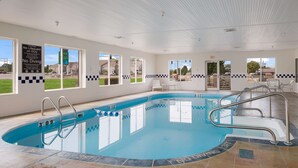 An indoor swimming pool with clear signage, including a 'No Diving' notice, and a view of the outside through large windows. - Sleep Inn & Suites Port Clinton (Port Clinton)