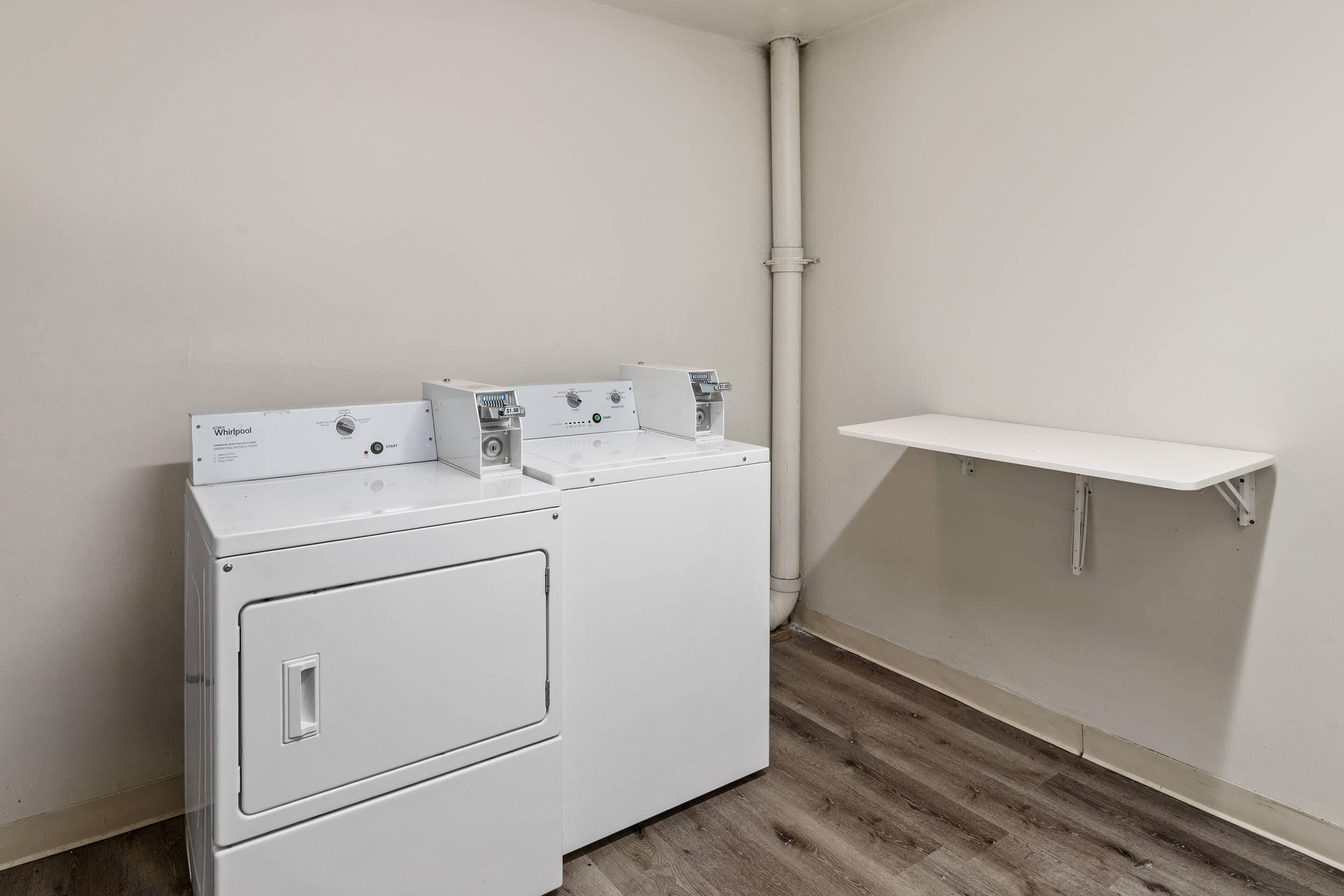 A white washer and dryer unit with a small shelf above it.