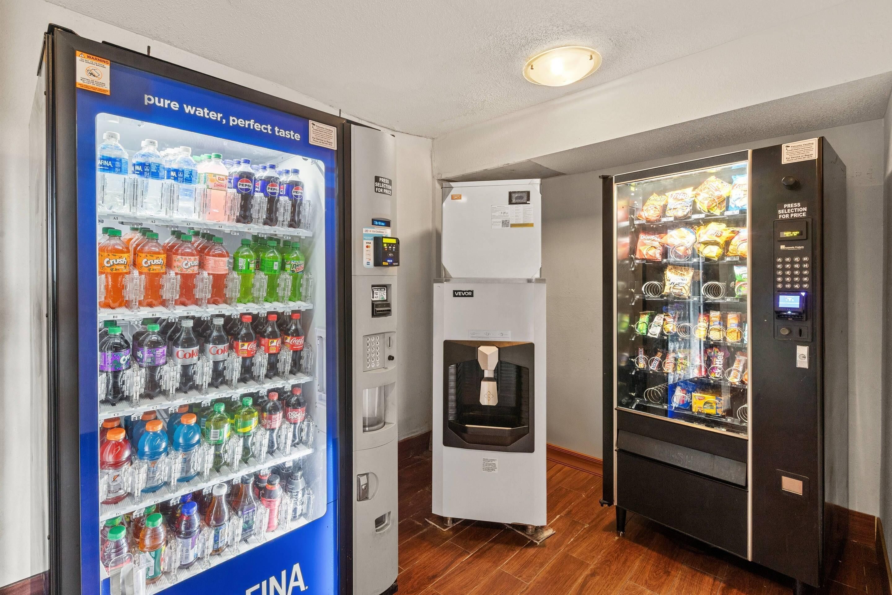 A vending machine area with a water dispenser and snack vending machines.