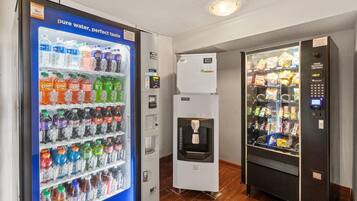 A vending machine area with a water dispenser and snack vending machines.
