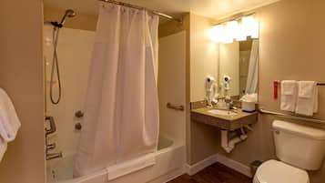 Un baño con bañera, ducha, inodoro, lavabo y espejo.
