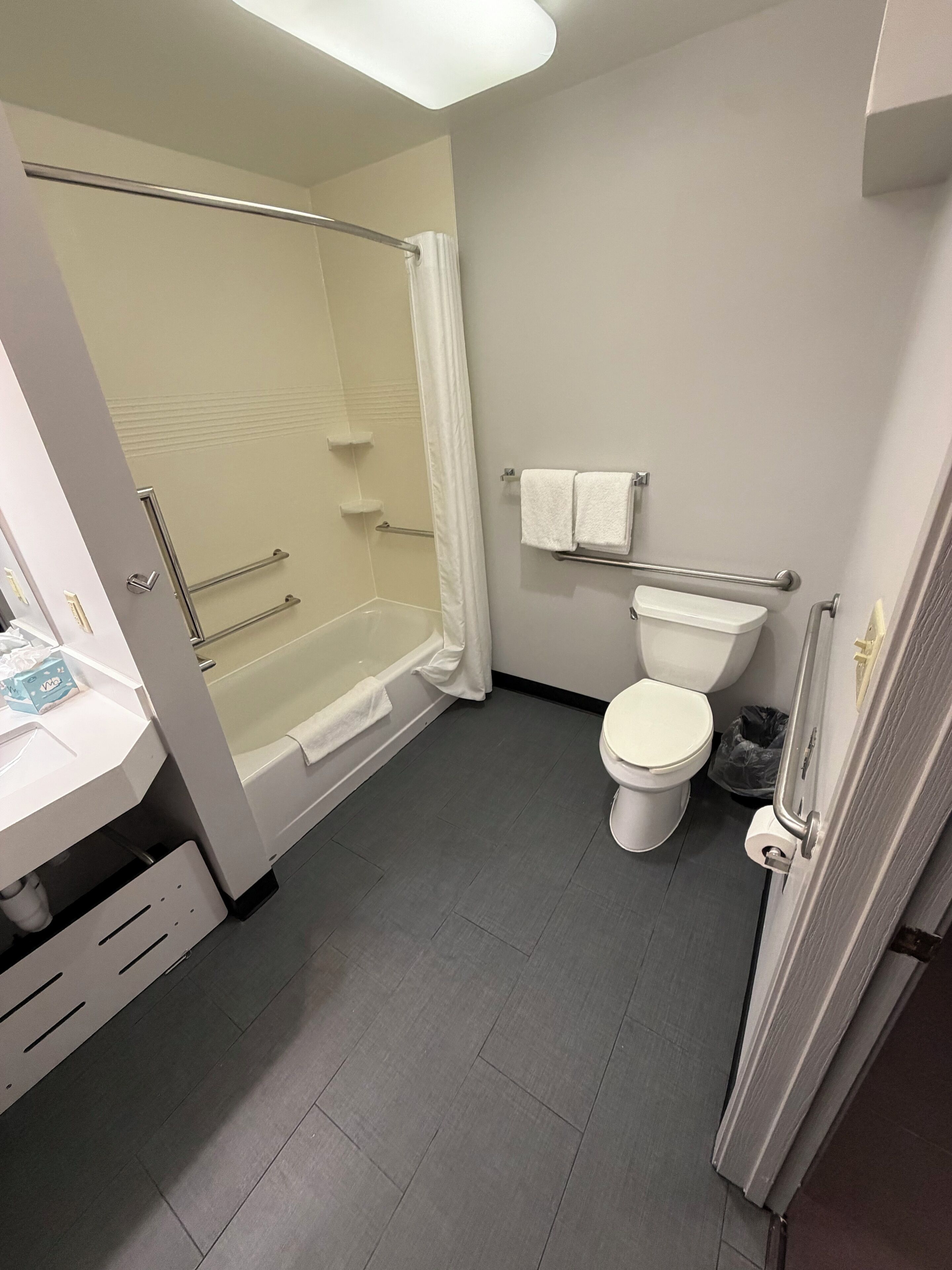 A bathroom with a bathtub, toilet, and shower.