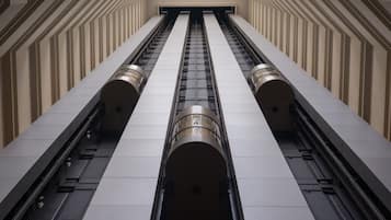 A modern elevator shaft with a geometric design and metallic accents.