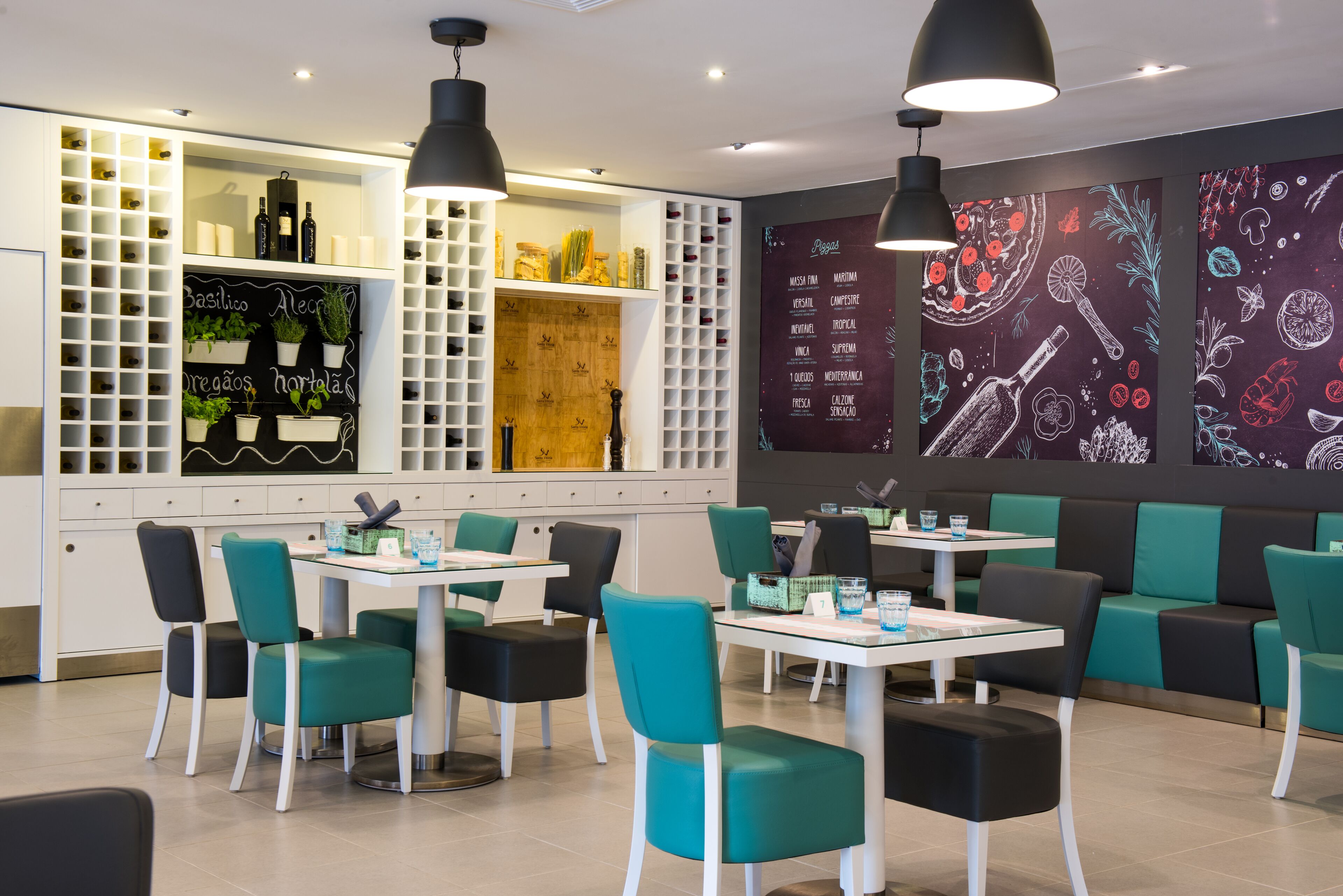 A modern restaurant interior with white and teal chairs, black pendant lighting, and a menu wall with food illustrations.
