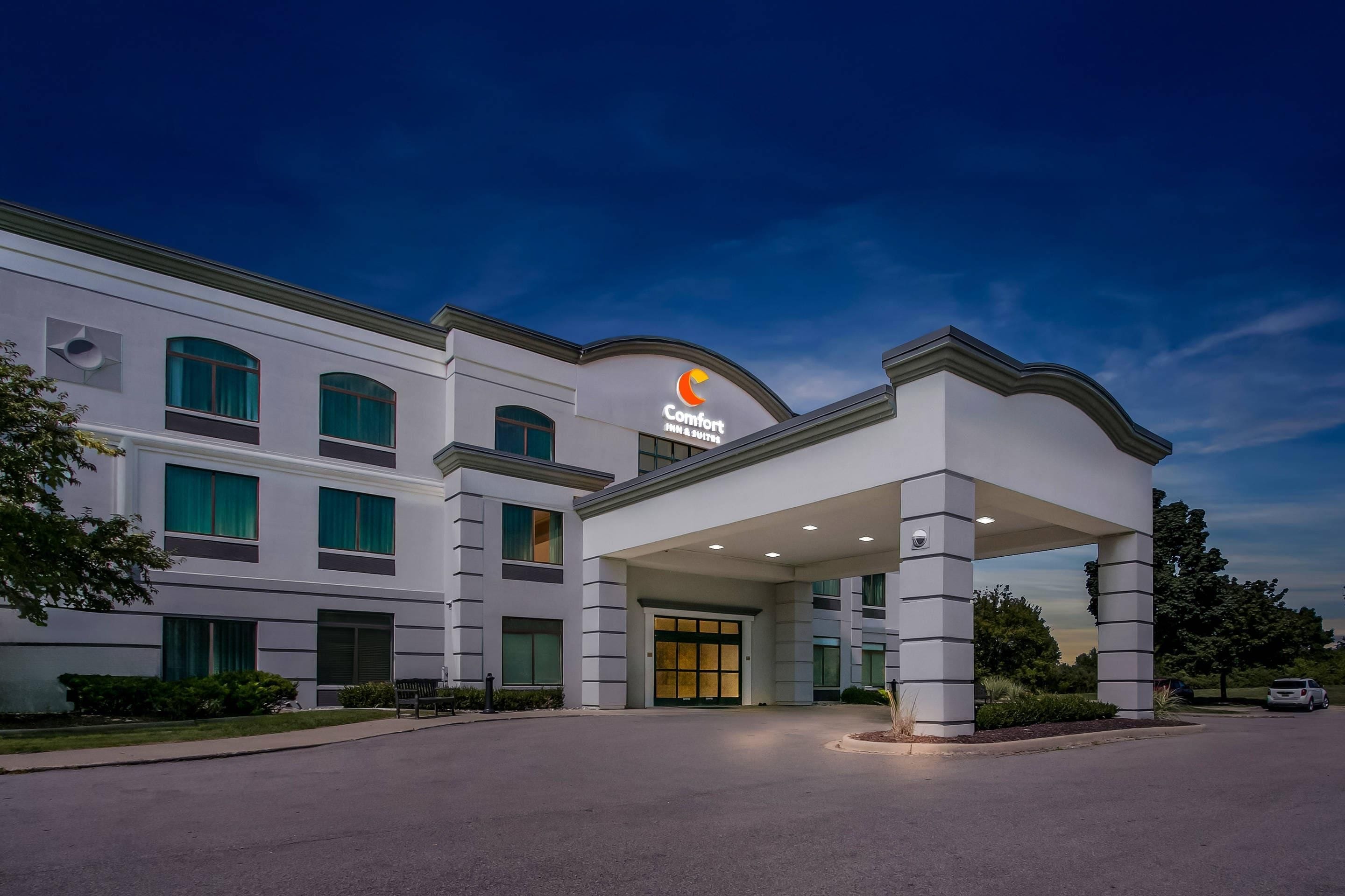 A hotel with a modern design, featuring a prominent entrance and a well-lit facade.
