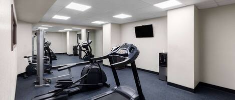 A gym with treadmills, elliptical machines, and weight equipment.
