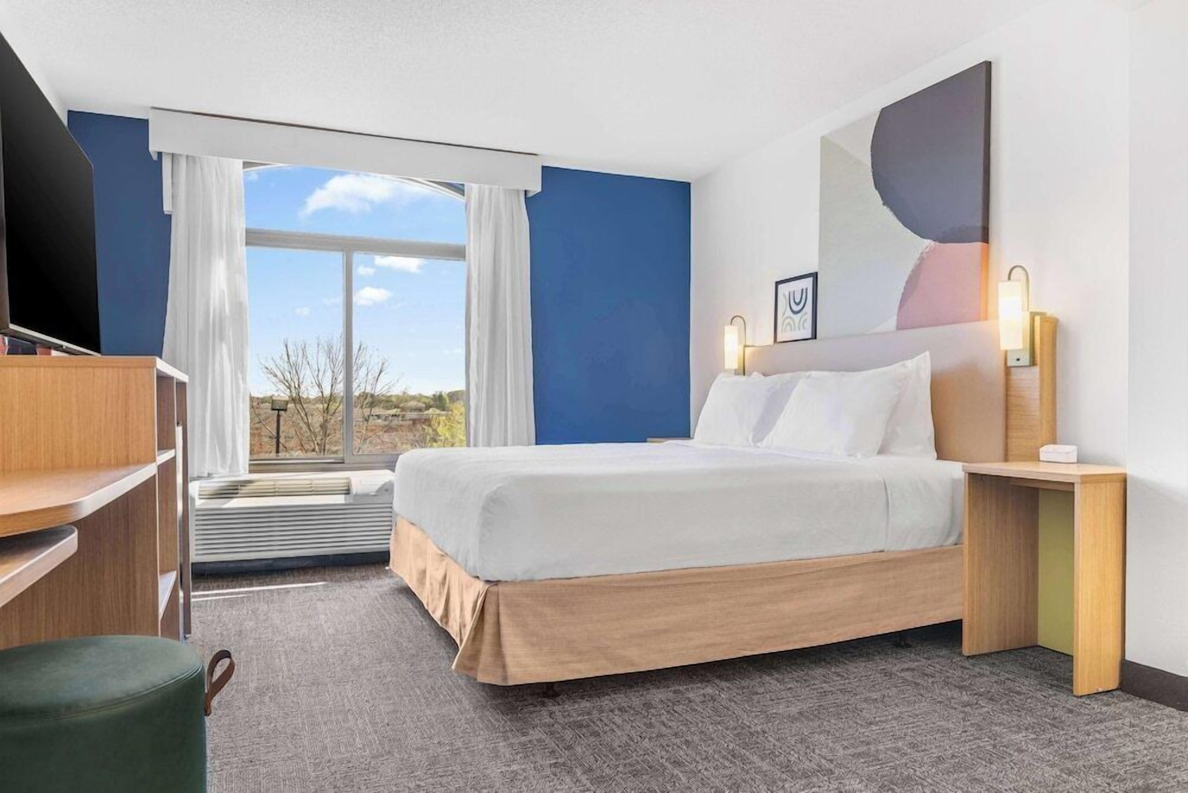 Premium bedding, desk, laptop workspace, blackout curtains