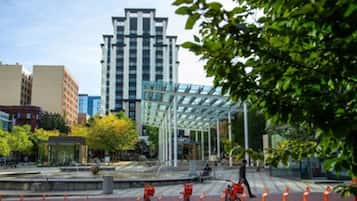 A modern building with a glass facade and a covered outdoor area.