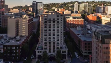 A multi-story building with a central courtyard, surrounded by other buildings.