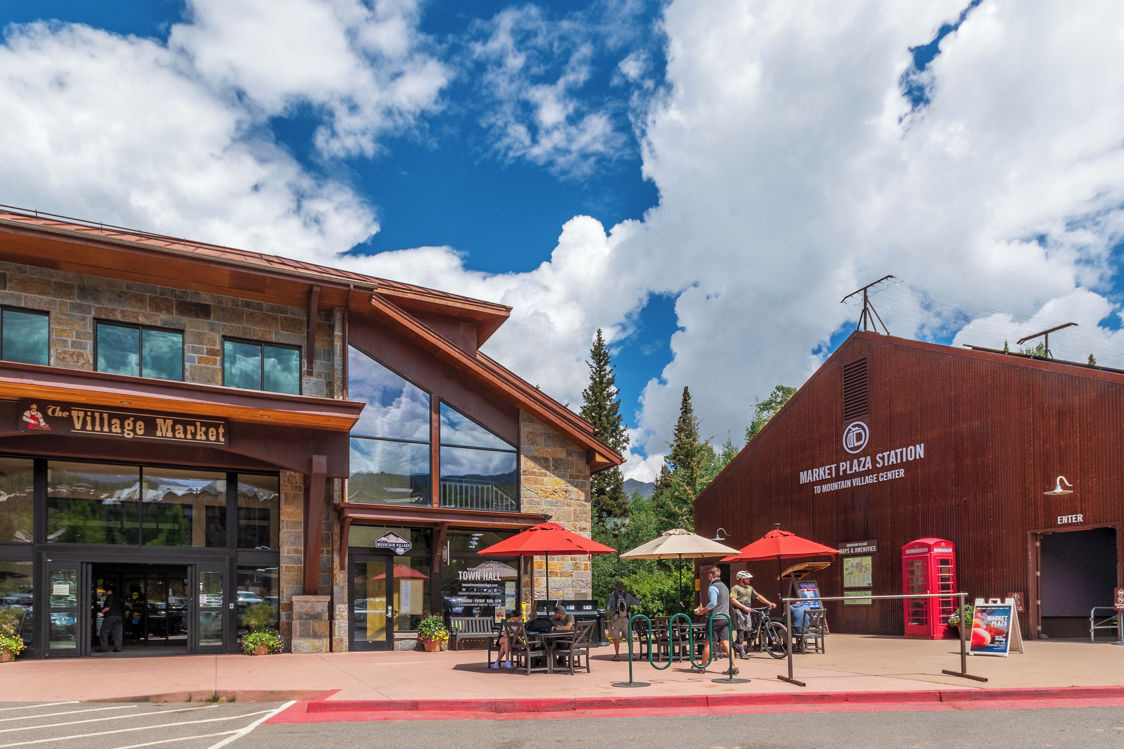 A building with a storefront labeled "Village Market" and a sign for "Market Plaza Station."