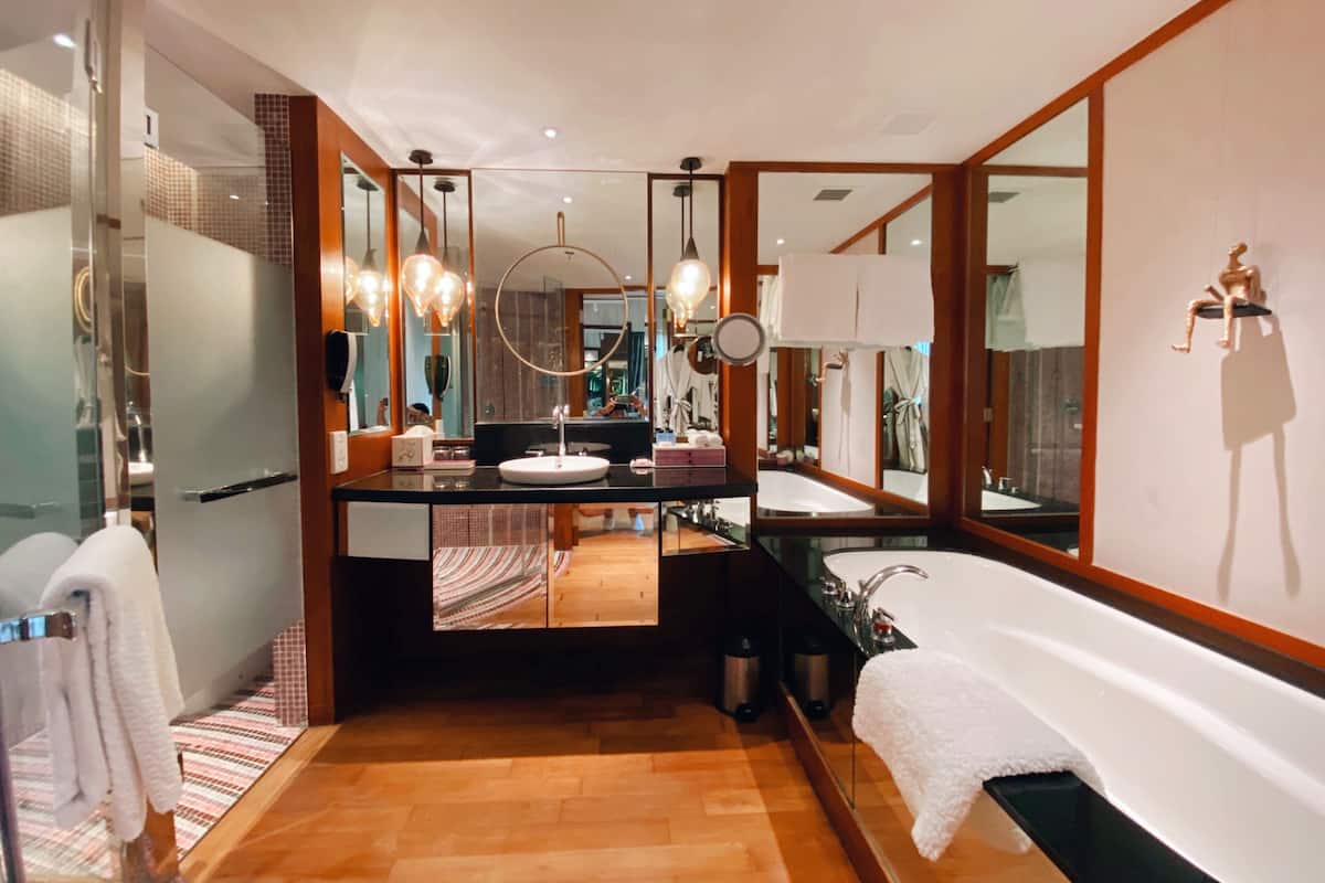 separate bathtub and shower, rainfall showerhead, designer toiletries