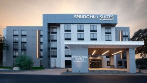 A modern hotel with a flat facade and a prominent entrance.