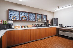 A modern kitchen with a wooden countertop, a microwave, a coffee maker, and a toaster. - Country Inn & Suites by Radisson, Savannah Southside (Savannah)