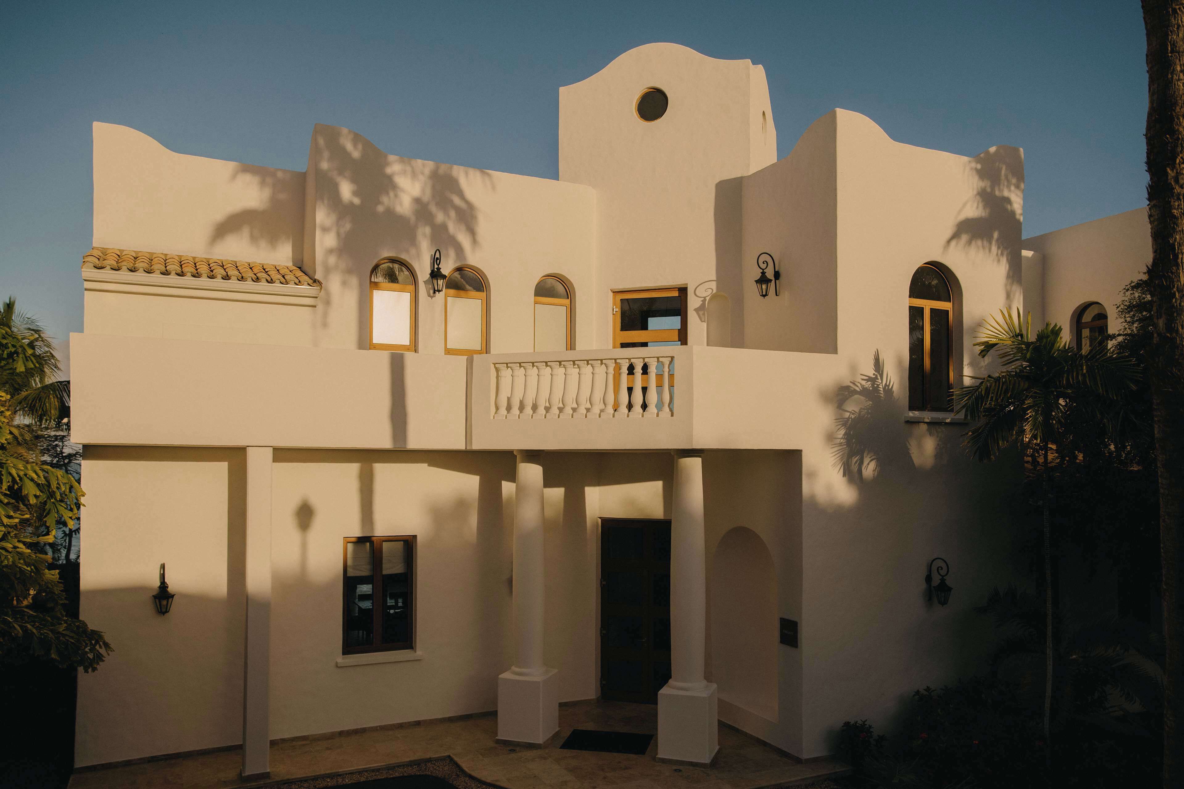 A building with multiple balconies, arched windows, and a central entrance.