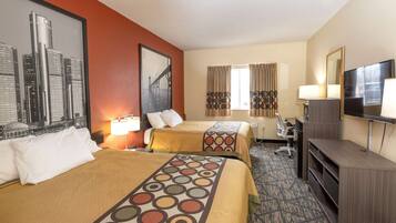 A hotel room with two beds, a desk, a TV, and a window with curtains.
