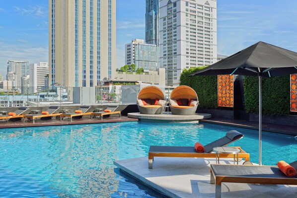Outdoor pool, open 7:00 AM to 9:00 PM, pool umbrellas