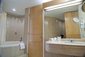 Bathtub, designer toiletries, hair dryer, towels