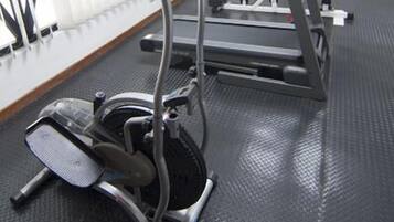 A gym with treadmills, an elliptical, and a weight machine.