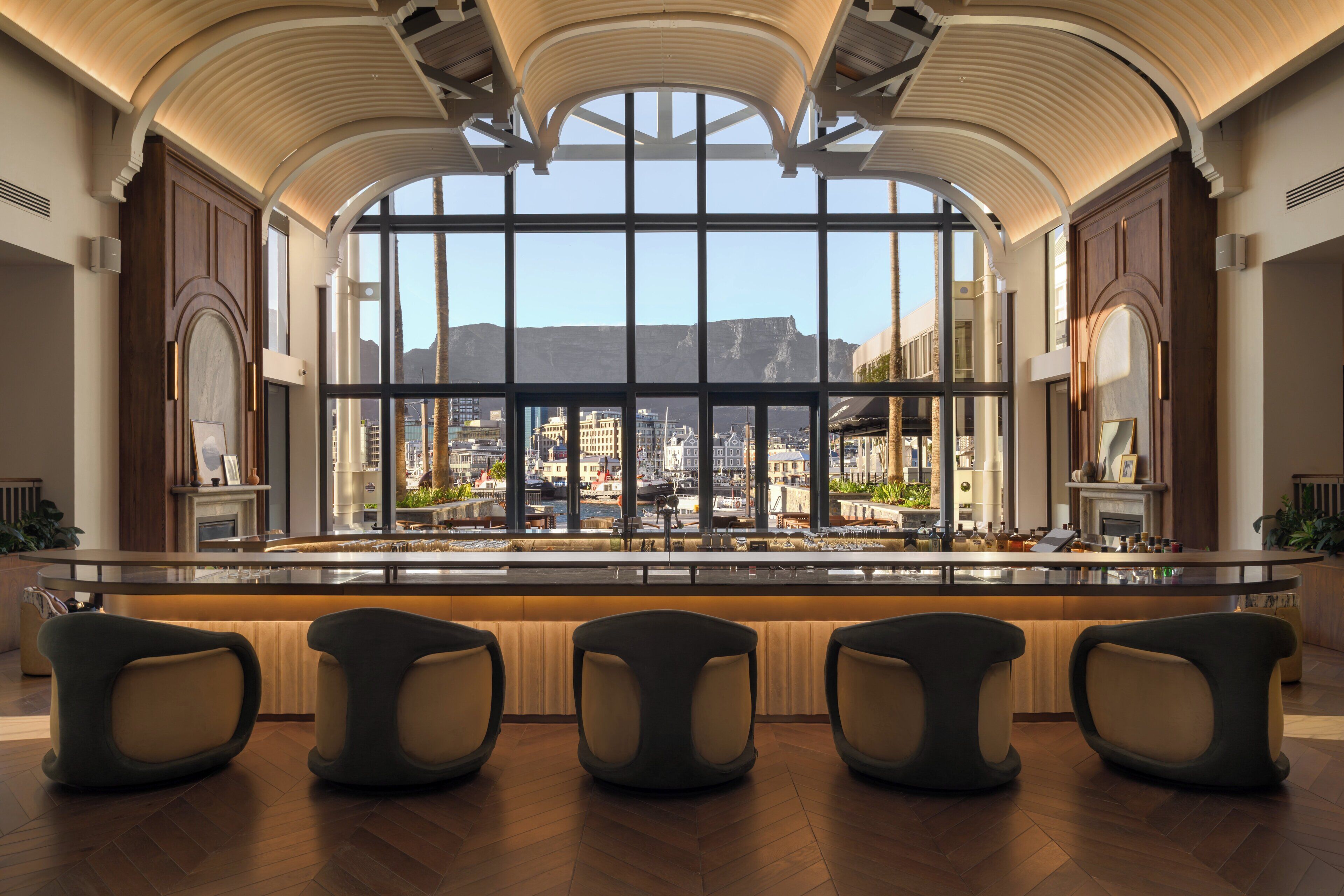 A spacious bar area with a large window offering a view of the cityscape.