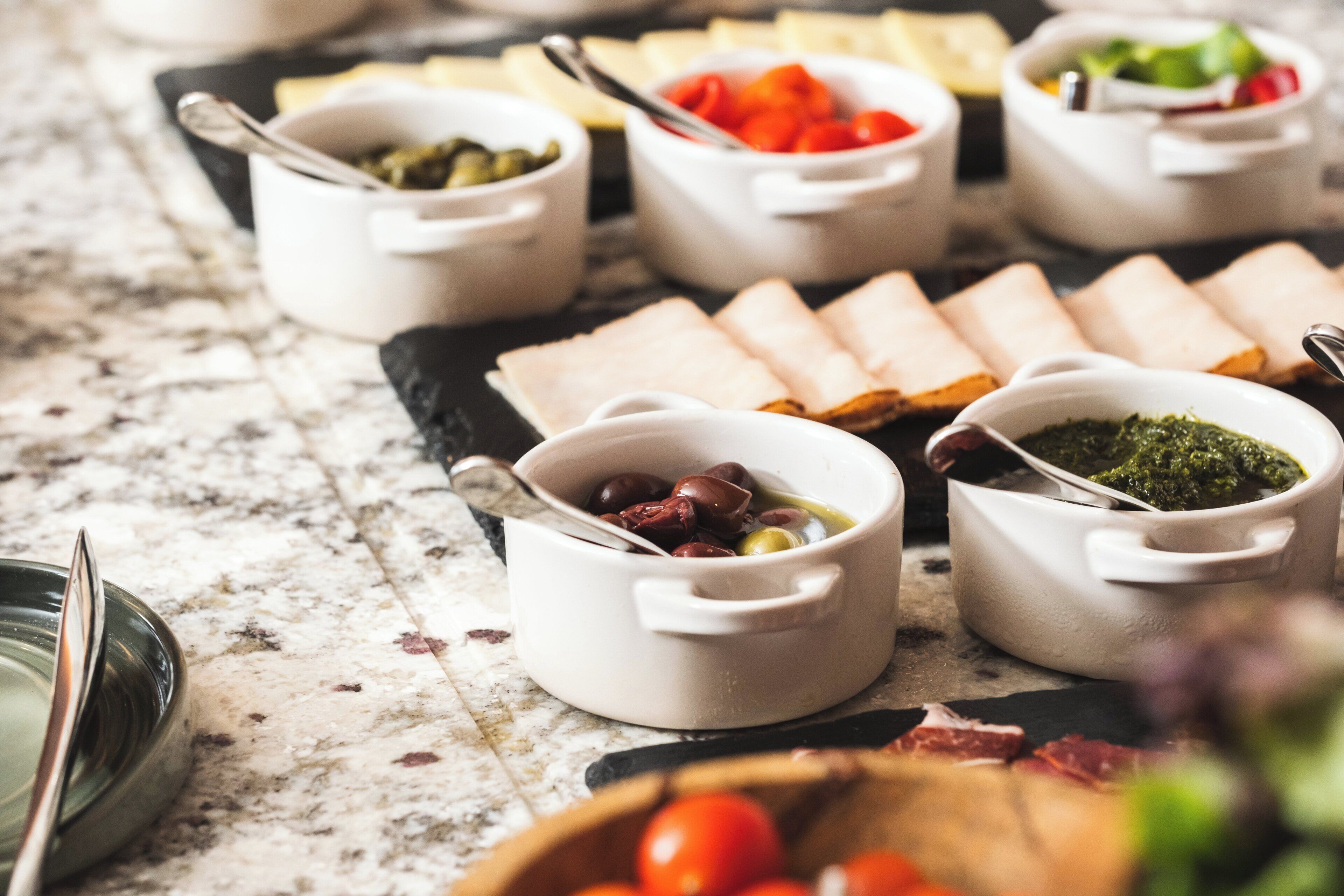 A variety of food items displayed on a marble countertop.
