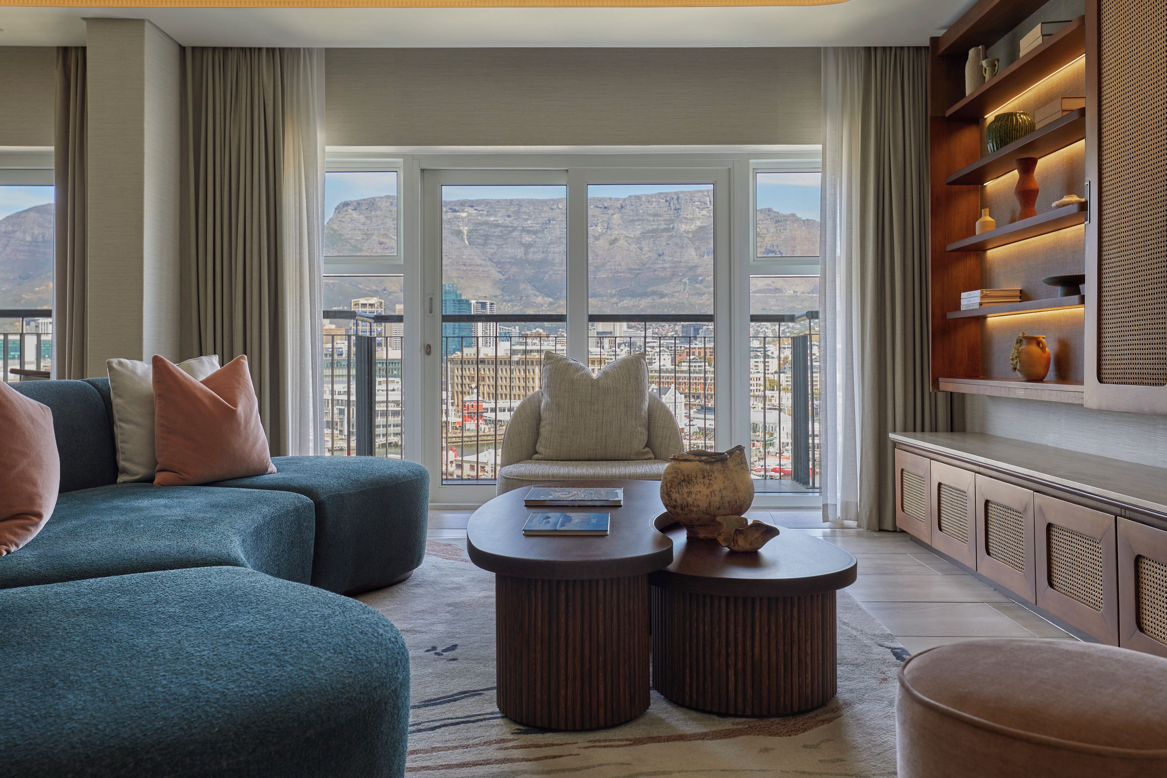A modern living room with a sofa, a coffee table, and a bookshelf.