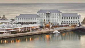 A waterfront hotel with multiple buildings, a dock, and a boat. - InterContinental Table Bay Cape Town by IHG (Cape Town)