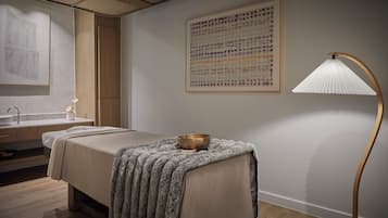 Un dormitorio moderno con cama, mesita de noche, lámpara, una obra de arte en la pared y un mueble de madera.