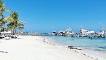 Privat strand, vit sandstrand, solstolar och parasoller
