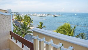 A marina with boats, palm trees, and a clear sky. - All Ritmo Cancun Resort & Water Park - All Inclusive (Cancun)