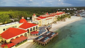 A resort with a pool area, beach access, and a view of the ocean. - All Ritmo Cancun Resort & Water Park - All Inclusive (Cancun)