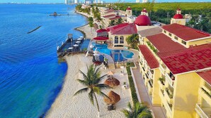A resort with a swimming pool, beach, and ocean view. - All Ritmo Cancun Resort & Water Park - All Inclusive (Cancun)
