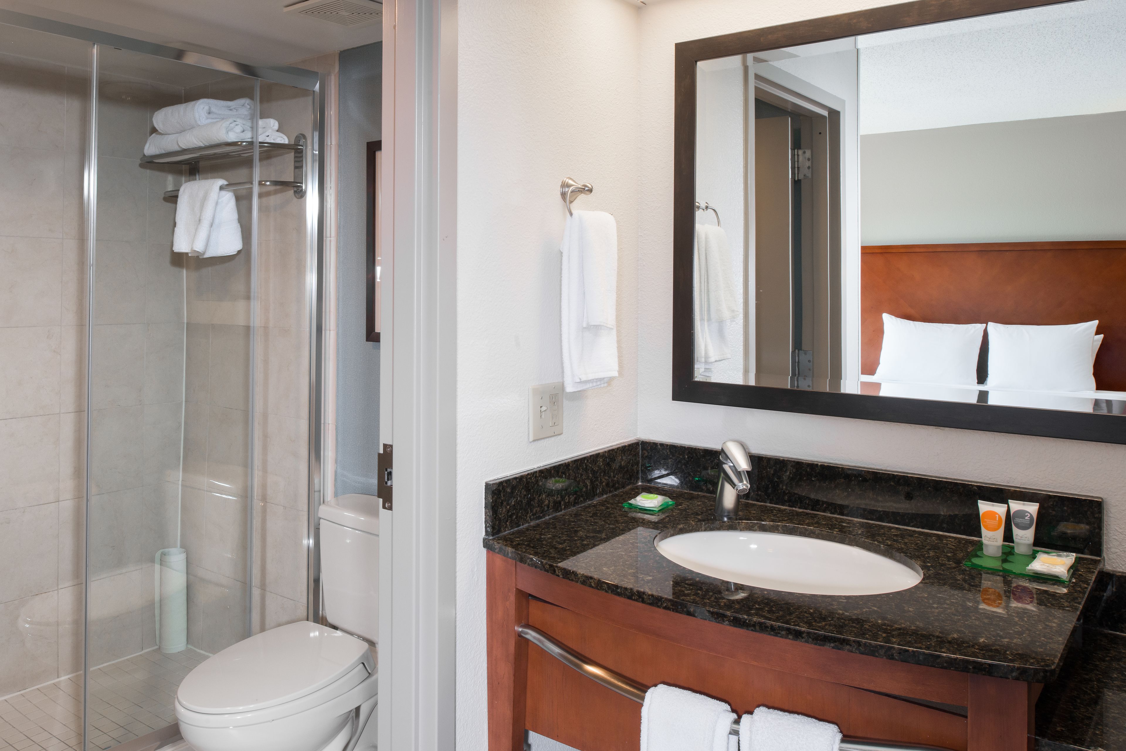 designer toiletries, hair dryer, towels