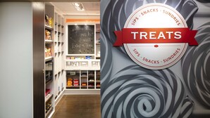 A store interior with shelves stocked with snacks and a chalkboard with a message. - Hampton Inn & Suites N. Ft. Worth-Alliance Airport (Fort Worth)