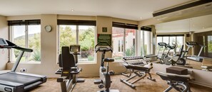 A gym with treadmills, elliptical machines, and weight equipment.
