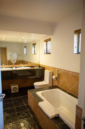 Suite | Bathroom | Separate bathtub and shower, designer toiletries, hair dryer