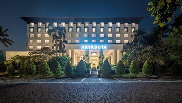 A multi-story hotel with a prominent entrance, a well-lit facade, and a landscaped front garden. - Aryaduta Lippo Village (Curug)