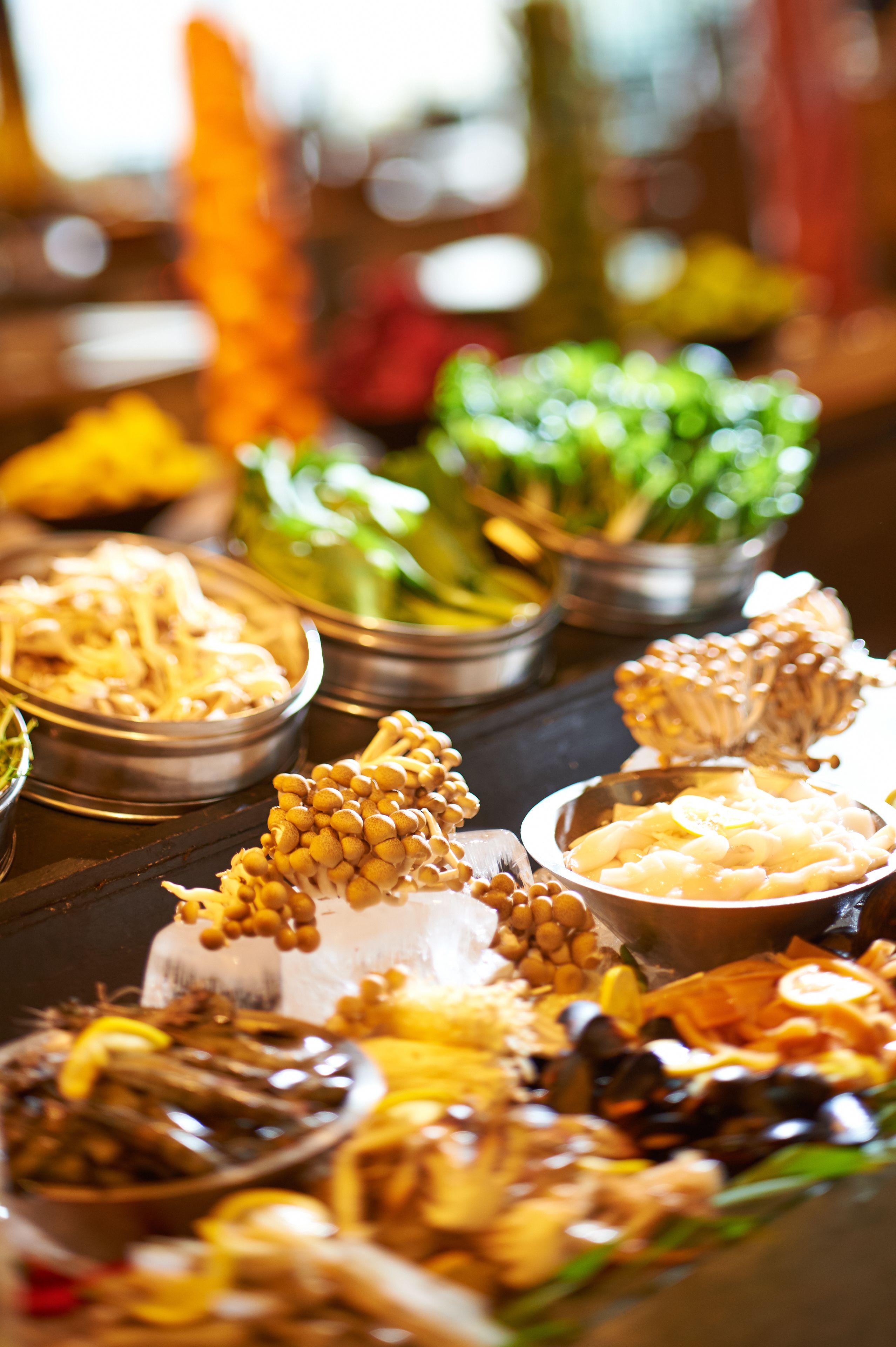 A buffet with various dishes including seafood, vegetables, and other prepared foods.