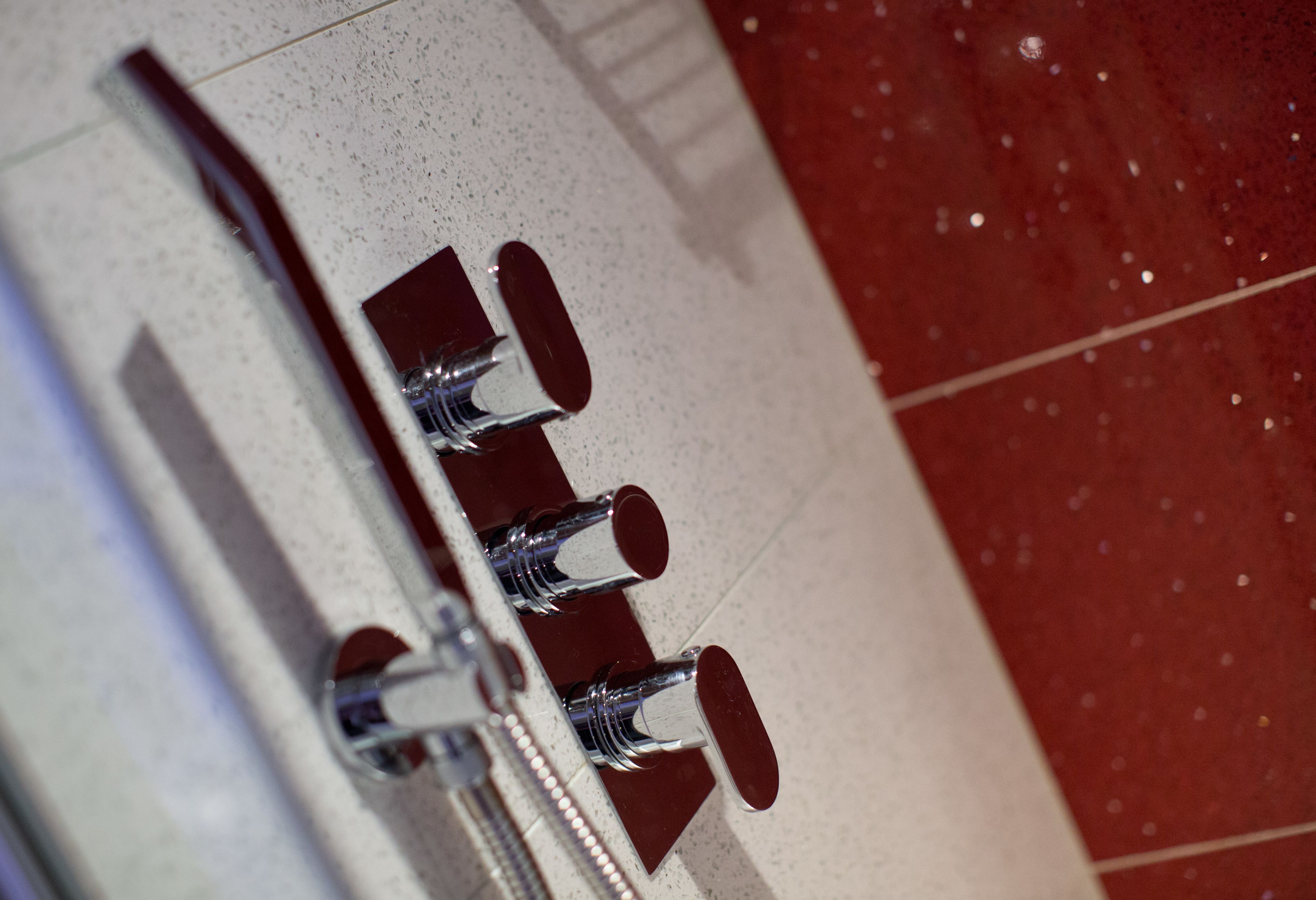 A close-up of a metallic object with a reflective surface, possibly a part of a piece of furniture or equipment.
